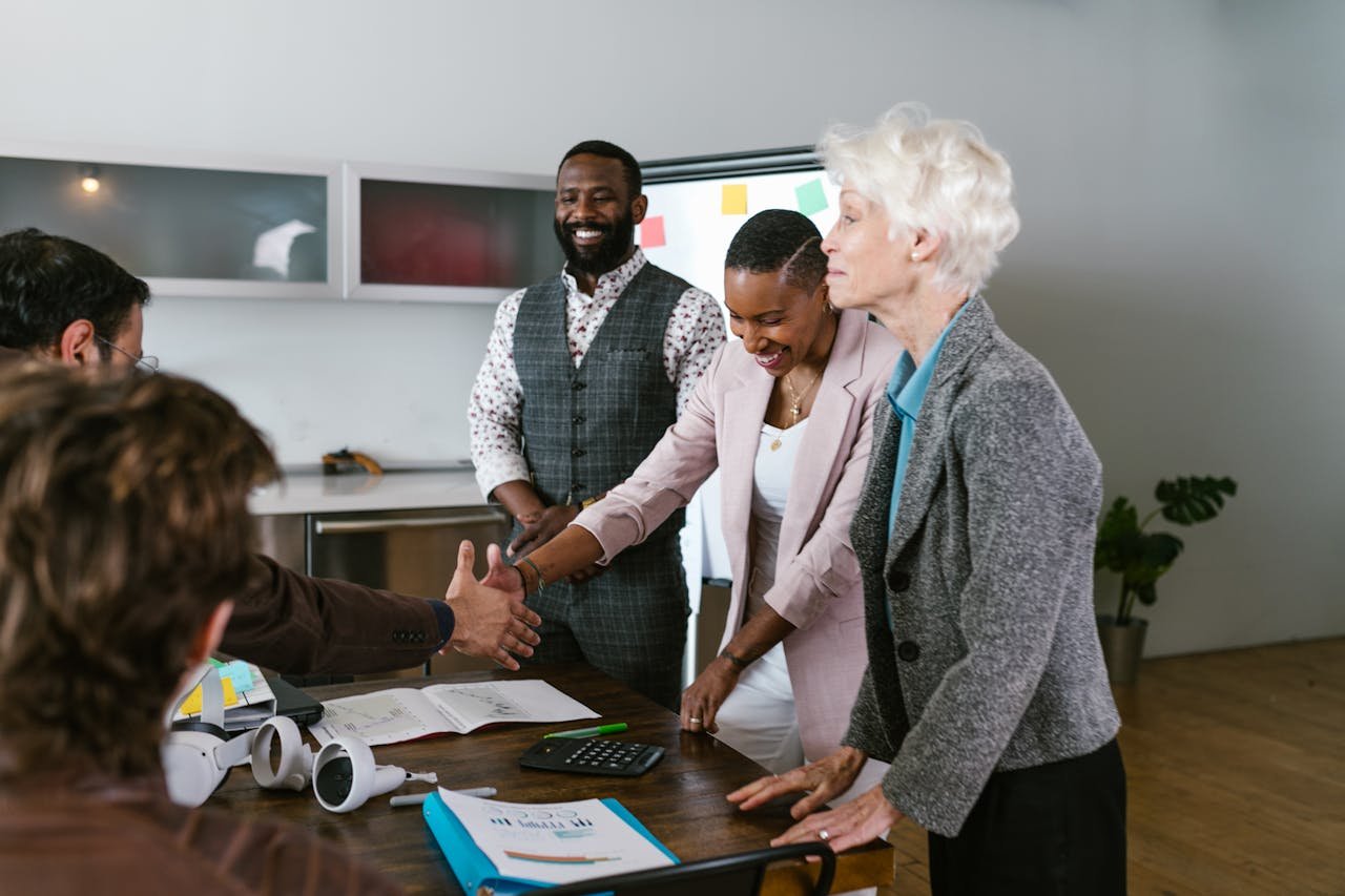 A group of diverse professionals engaged in a collaborative business meeting indoors.